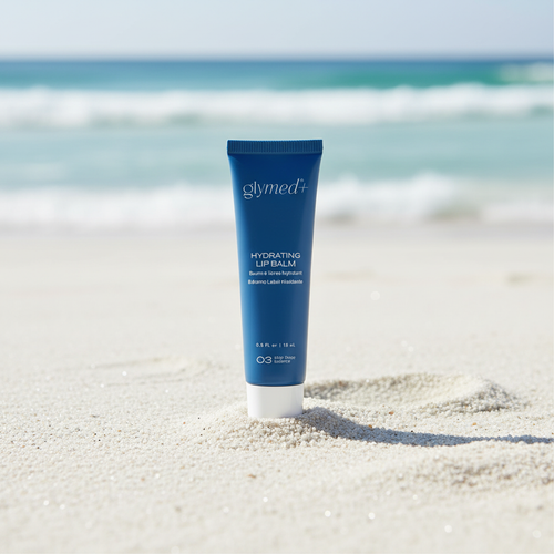 Hydrating Lip Balm standing upright in sand on beach